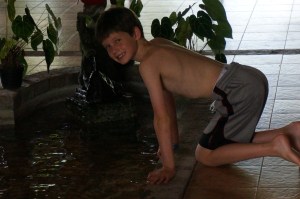 Fletcher catching tadpoles in the fountain in the middle of our house.